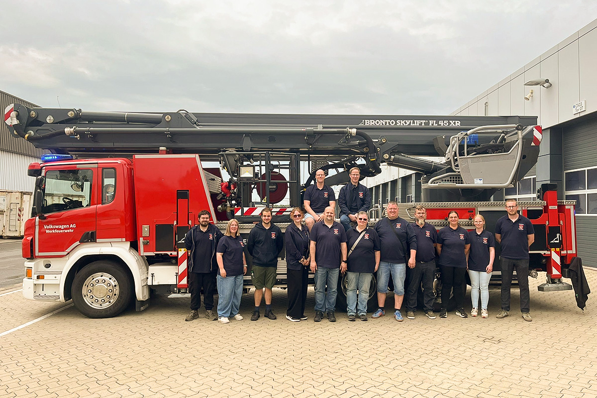 Kameradinnen und Kameraden der Freiwilligen Feuerwehr Bettrum vor der Teleskopmastbühne der  Werkfeuerwehr Volkswagen AG Wolfsburg.